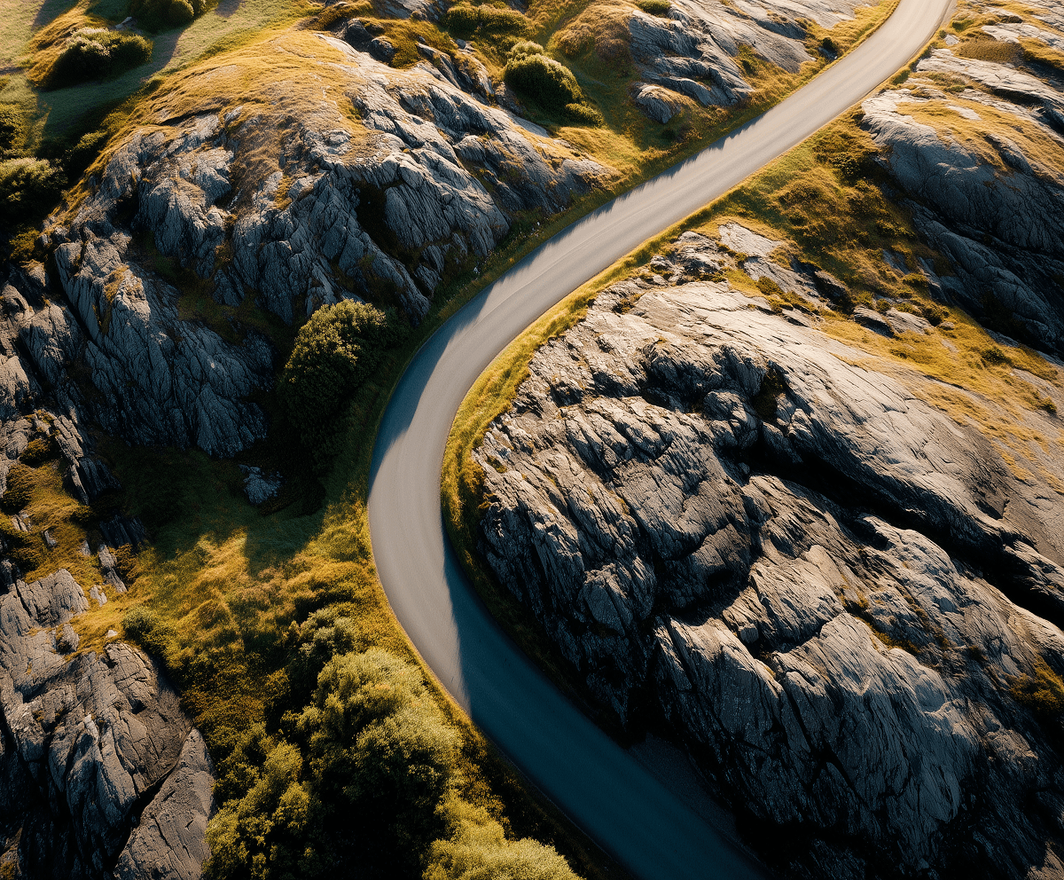 Aerial view of a winding road through rocky hills